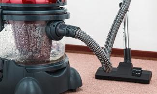 Black and Red Canister Vacuum Cleaner on Floor